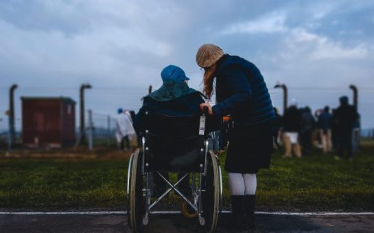 Someone leaning into another person in a wheelchair