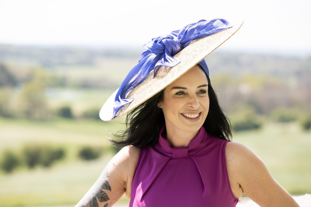 Brain Tumour patient Lisa Connell models a Jenny Roberts hat for the 'Hats Fit For A Queen' charity auction.