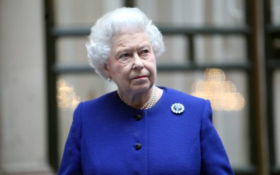 The Queen dressed in navy blue with a qhite background including black framing