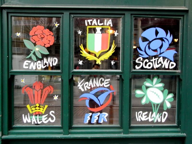The badges of each Six Nations side painted onto a window pane.