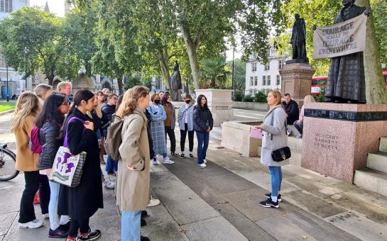 Tour group of women outside statue of Millicent Fawcett in Westminster