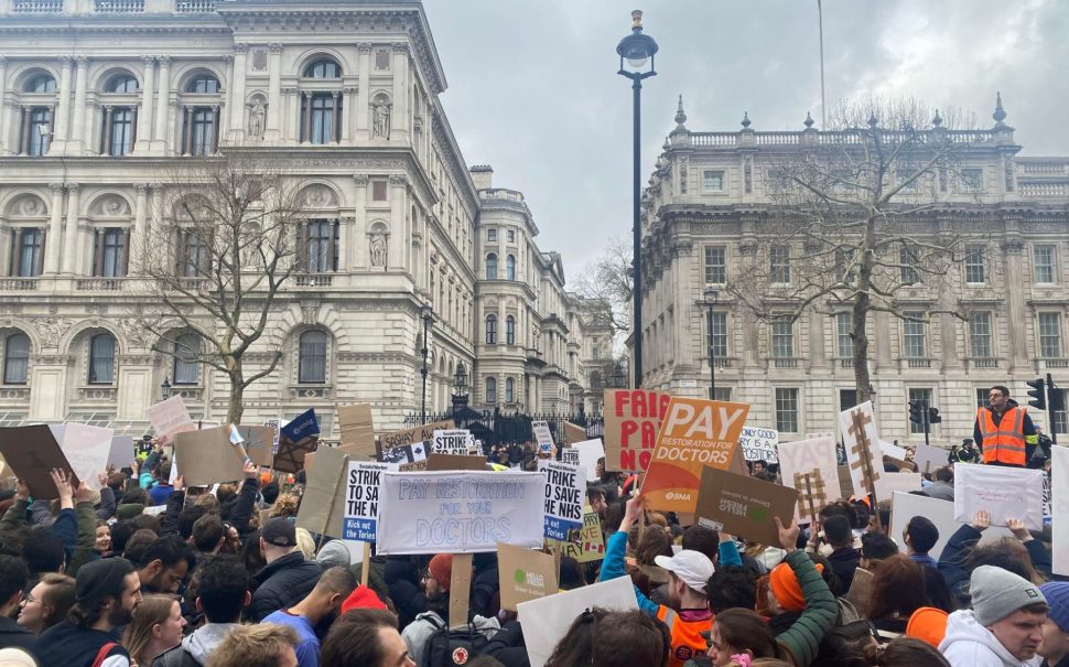 Photograph demonstrating protestors holding signs outside Westminster
