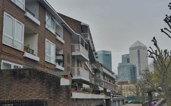Low income housing in the Poplar area. The Canary Wharf skyscrapers are seen in the background.