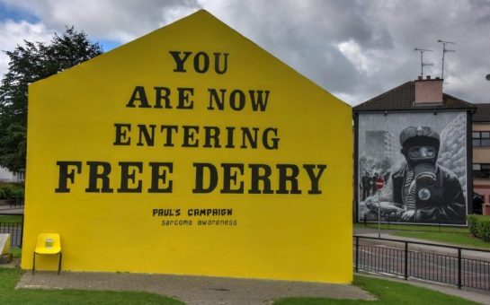 The Free Derry mural - an icon of the 'Troubles' - is repainted to reflect Norther Ireland's modern problems - a campaign to promote awareness for sarcoma cancer.