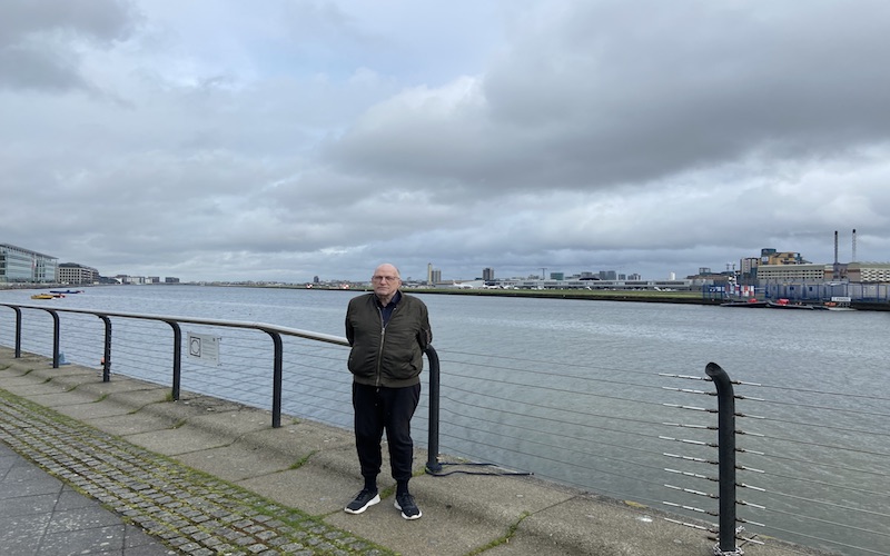 John Roberts stands in front of London City Airport runway