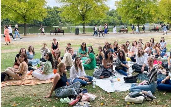 Group of women sitting in a park having a picnic