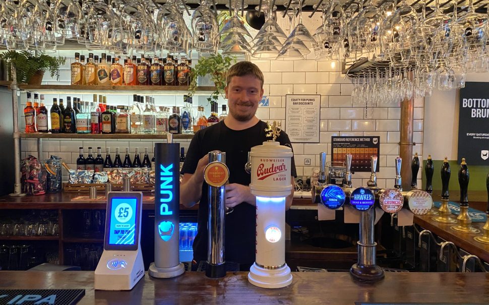 James Barnes-Smith pulling a pint of charity beer 'Tropical Tom' at Seething Lane Tap pub.