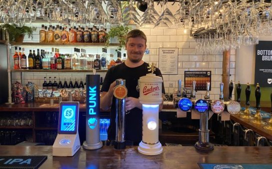 James Barnes-Smith pulling a pint of charity beer 'Tropical Tom' at Seething Lane Tap pub.