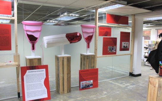 Exhibition at the Vagina Museum. There are giant tampons and diva cups covered in red glitter to represent menstrual blood
