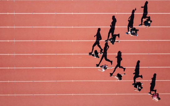 Group of athletes running on a track