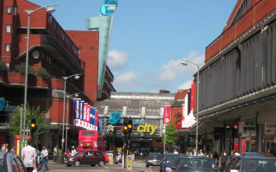 A view from the road of Wood Green Shopping Centre in Haringey, London, on a sunny day with a clear sky.