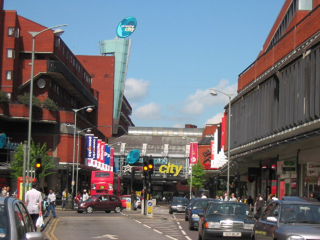 A view from the road of Wood Green Shopping Centre in Haringey, London, on a sunny day with a clear sky.