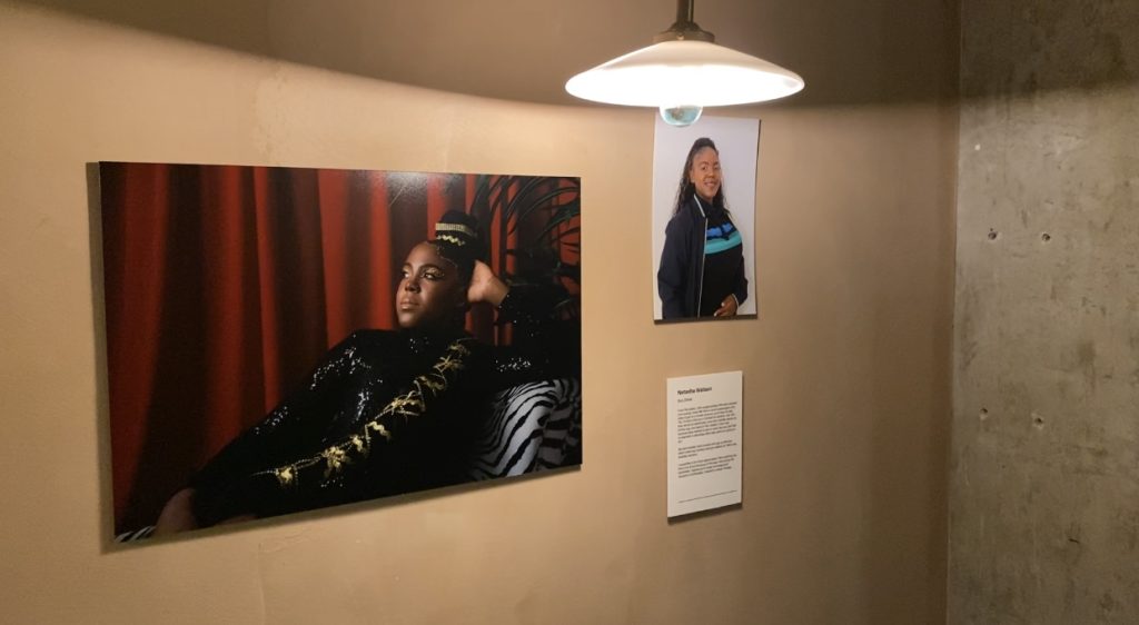 An image from inside the gallery that shows one of the women on the frontlines in a boudoir portrait next to a professional headshot.