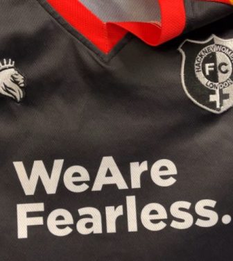 Hackney Women's black football kit with rainbow trim, which says 'We Are Fearless' written across the middle.