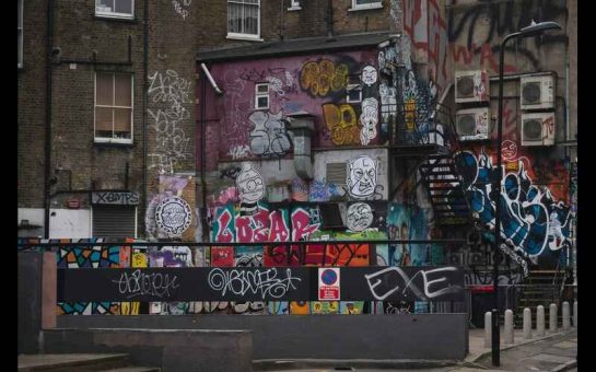 A wall of houses with graffiti