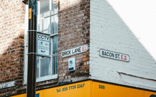 A photo of the street sign reading 'BRICK LANE'.
