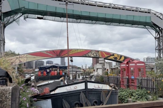 Image of house boat at Cody Dock and colourful bridge