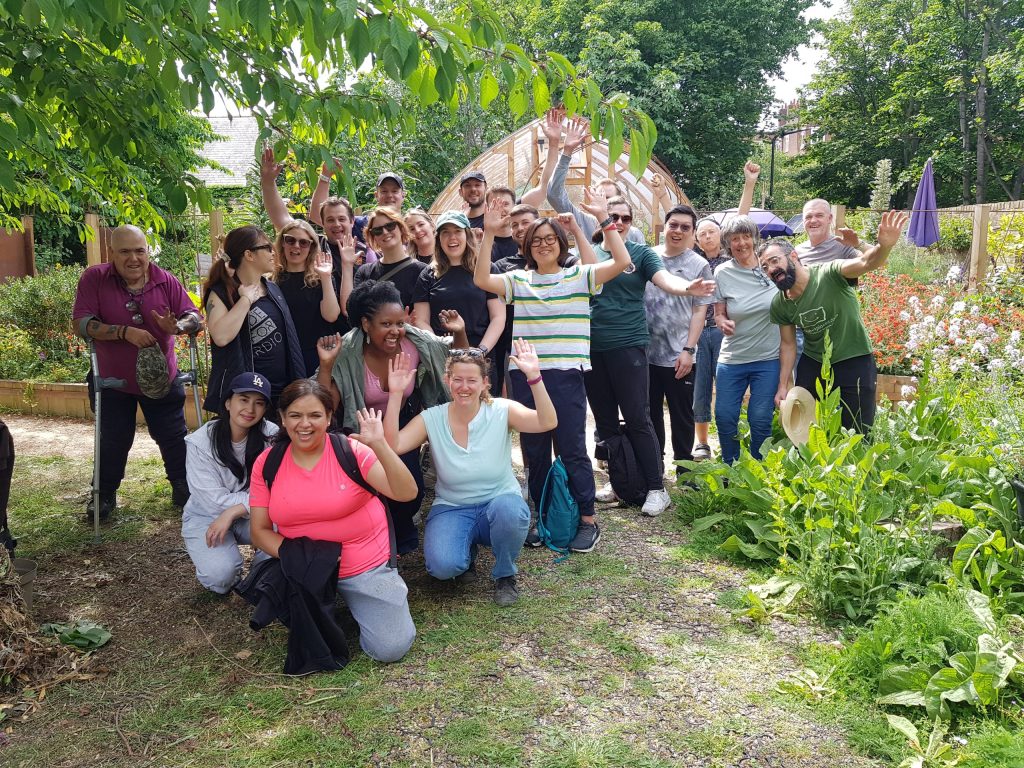 Volunteers pose for camera at Core Arts Community Garden behind St Barnabas Church in Homerton