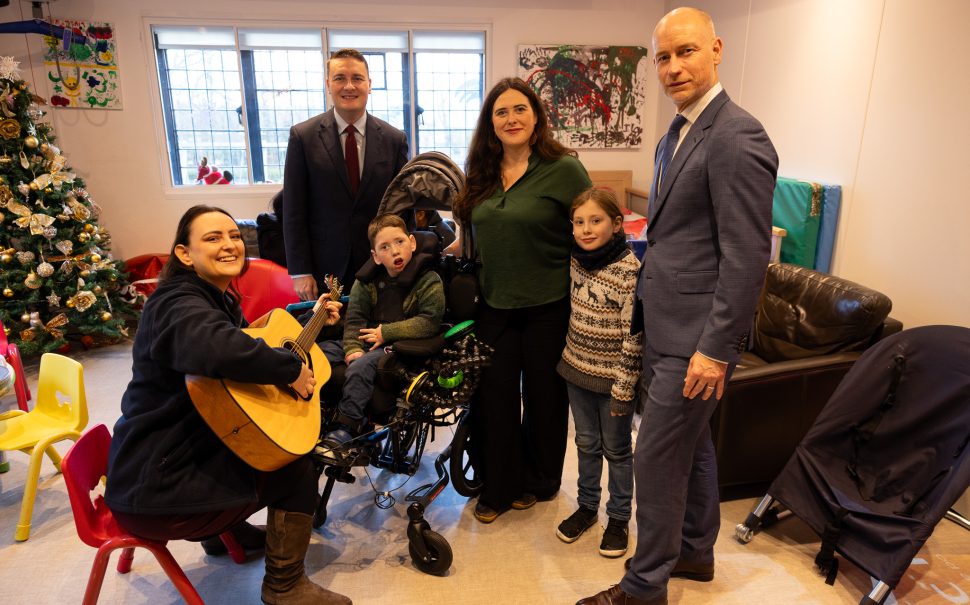 Wes Streeting and Stephen Kinnock visit Haven House in December 2024 to make capital funding announcement. They feature with Haven House's music therapist and mum Amanda and child Charlie.