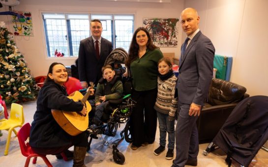 Wes Streeting and Stephen Kinnock visit Haven House in December 2024 to make capital funding announcement. They feature with Haven House's music therapist and mum Amanda and child Charlie.