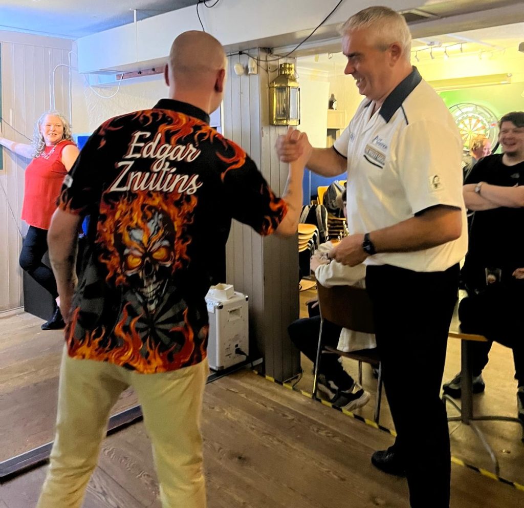 Znutins shakes hands with Steve Beaton after a game