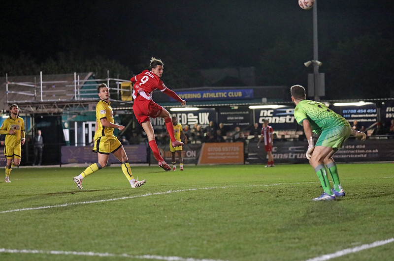 Hornchurch striker Henry Hearn scoring a header