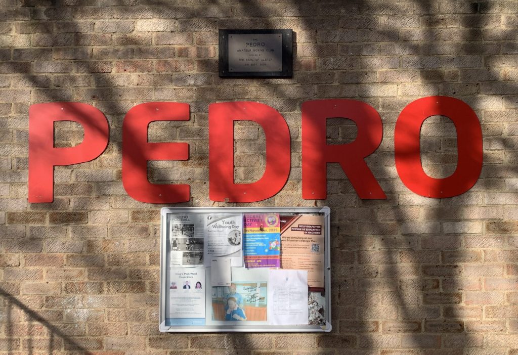 Red letters spelling Pedro on a brick wall