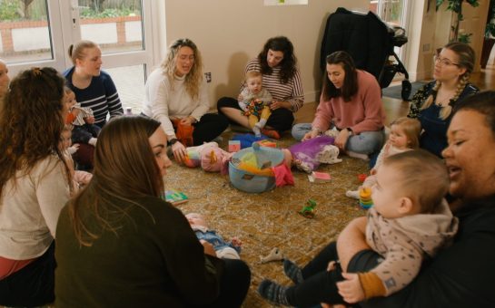 Mums sit in circle with their babies