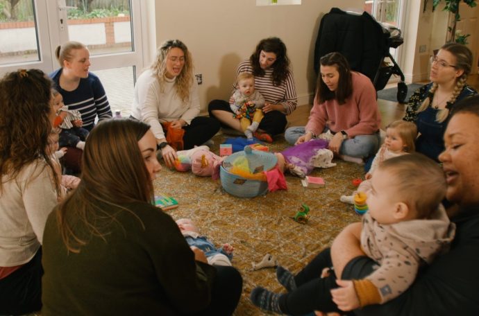 Mums sit in circle with their babies