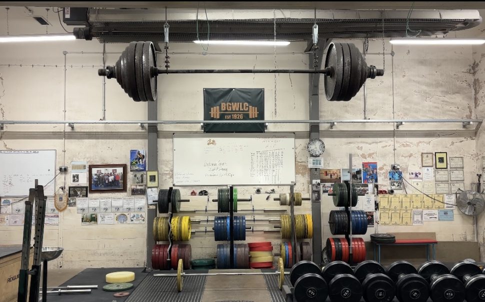 The Bethnall Green Weightlifting Gym standing empty, with a bar suspended from the ceiling.