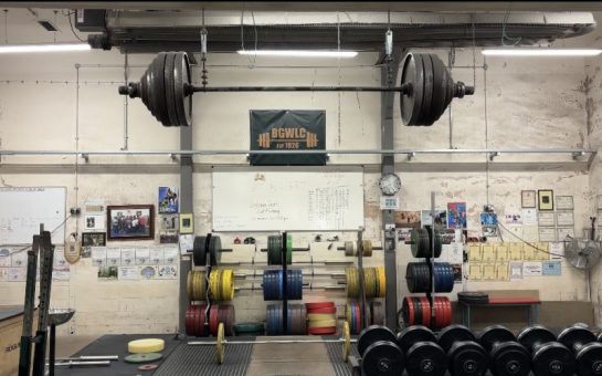 The Bethnall Green Weightlifting Gym standing empty, with a bar suspended from the ceiling.