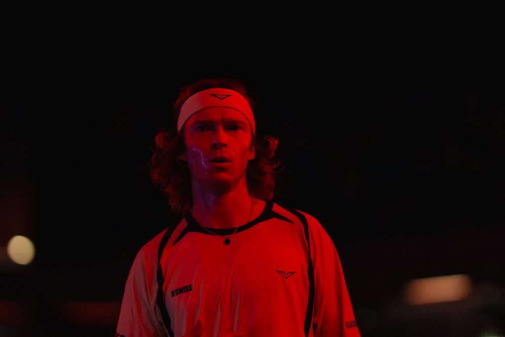 Andrey Rublev cloaked in the red light of the Bonus Button at the UTS Grand Final.