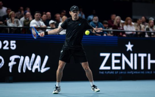 Alex De Minaur hits a tennis ball.