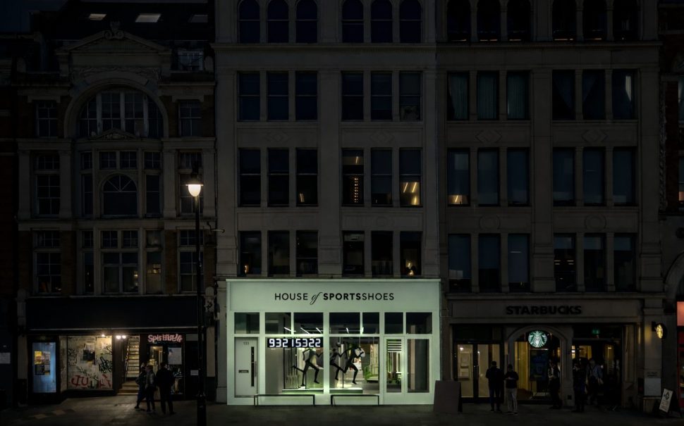 A mock-up image of the new House of SportsShoes store. It has a turquoise storefront and is shot in the dark.