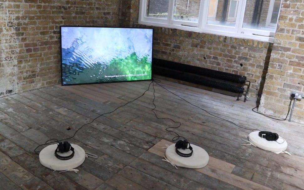 Headphones in front of a television screen as part of an interactive art exhibition