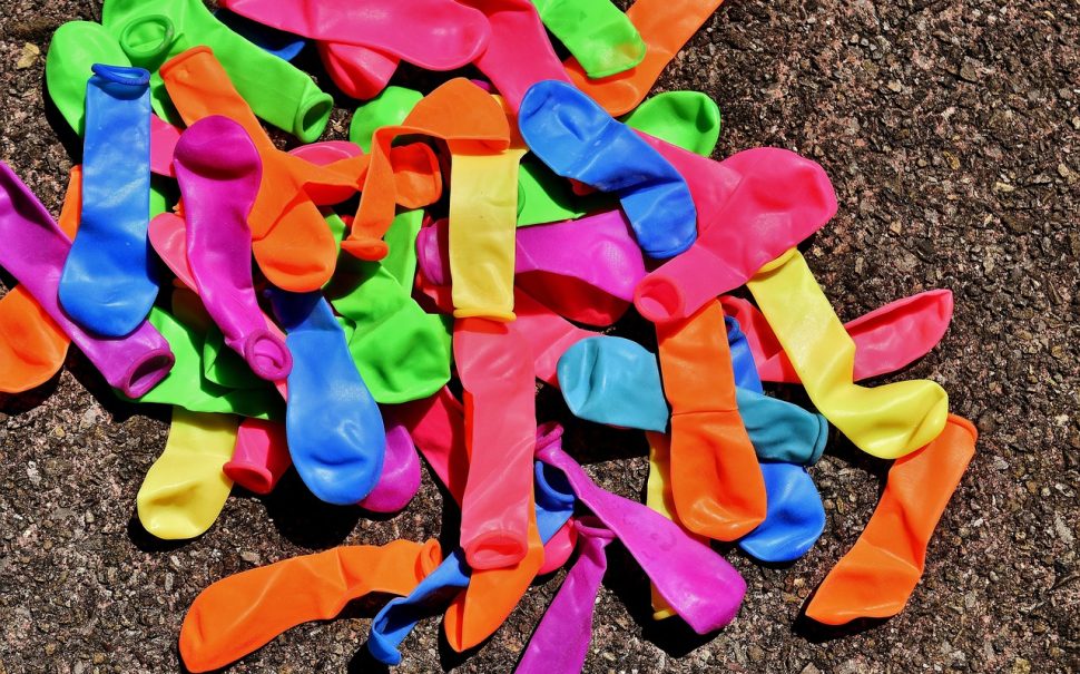 Colourful deflated balloons on the ground