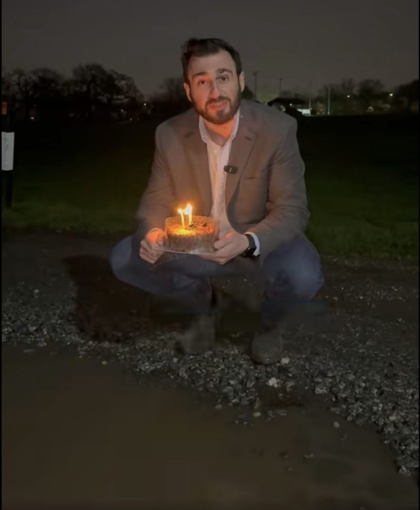 POTSHOTS: Cllr Alessandro Georgiou with a birthday cake for the year-old pothole