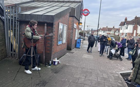 Man performs to crowd outside tube station