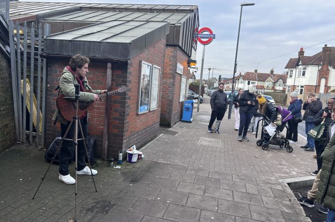 Man performs to crowd outside tube station