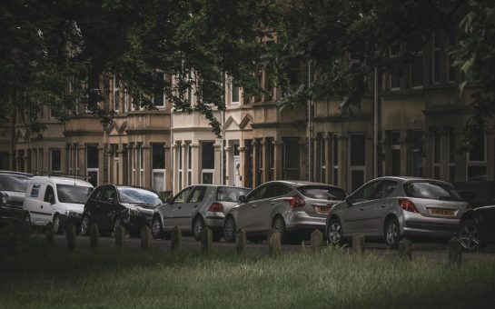 A row of cars parked on a residential street