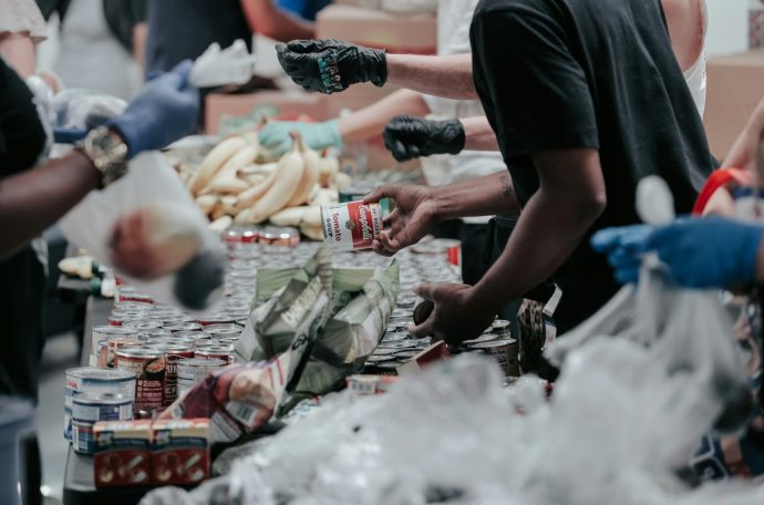 People hand out food in a foodbank