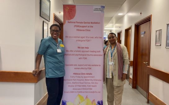 Brent FGM nurses pose by awareness poster in Northwick Park Hospital