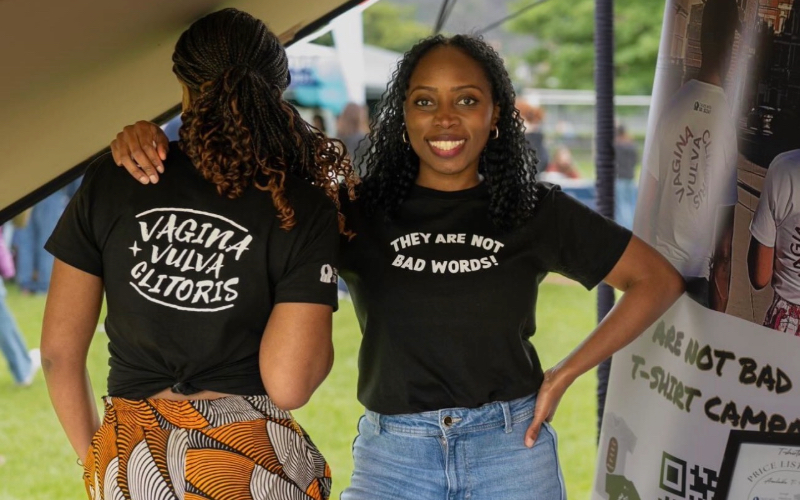 Dr Aiziza Sesay standing on the right and a woman wearing campaign shirt