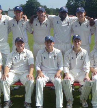 11-man cricket team posed for a team picture.