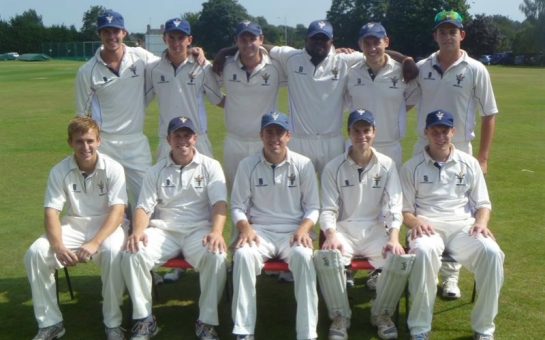 11-man cricket team posed for a team picture.