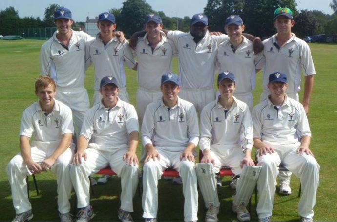 11-man cricket team posed for a team picture.