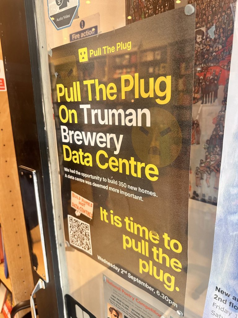 Poster affixed to door with text - "pull the plug on Truman Brewery data centre".
