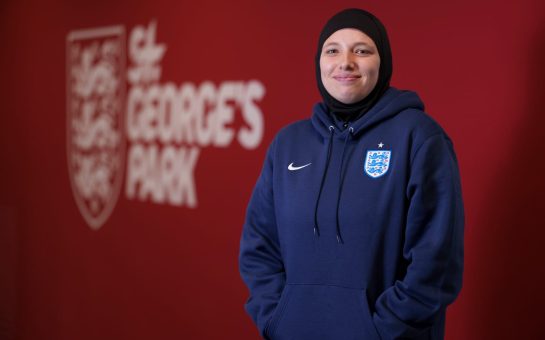 Hijabi coach standing in front of St George's Park sign