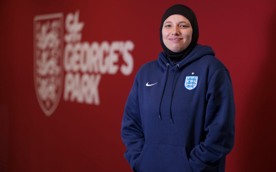 Hijabi coach standing in front of St George's Park sign