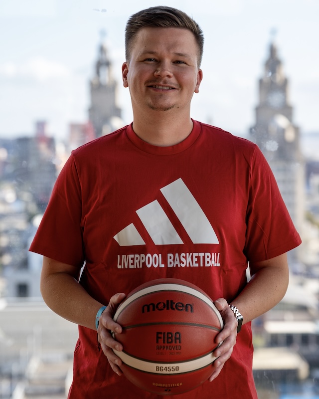 Presenter Josh Sexton holding a basketball.